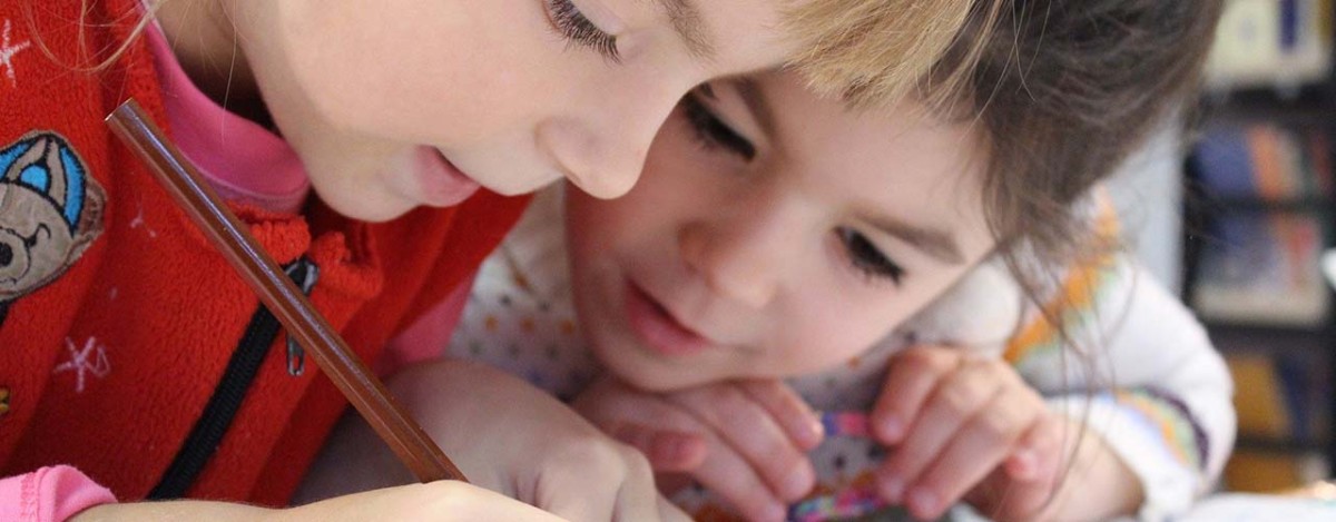 two children writing in school